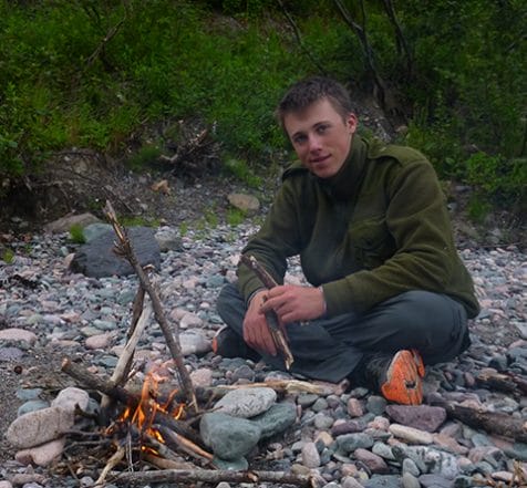 teen building a campfire