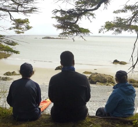 three indigenous youth looking out at Bay of Fundy