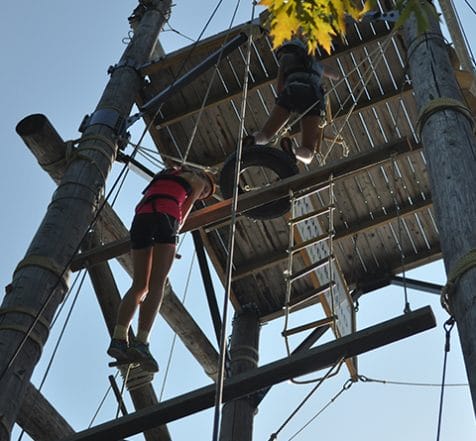 two-youth-climbing-high-ropes-structure