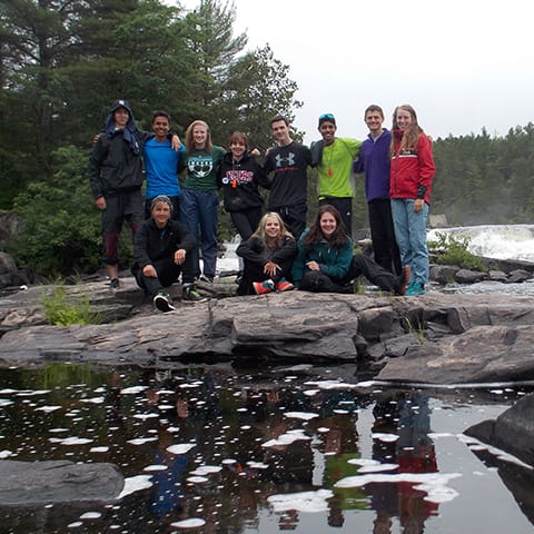 whitewater canoeing group in front of rapids