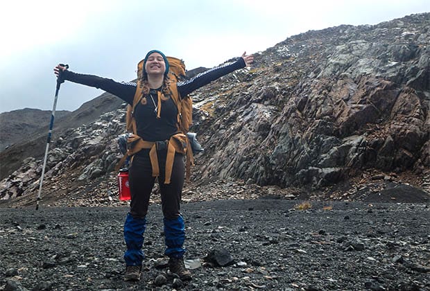 Image of a hiker with her arms outstretched