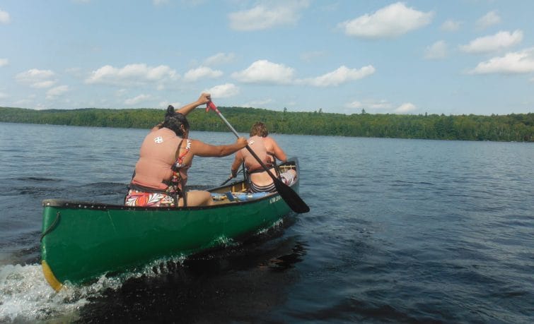 two people canoeing on a lake