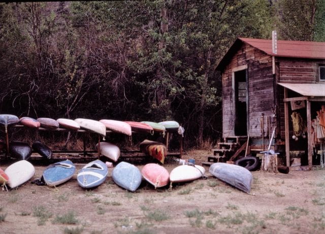 wood cabin with kayaks outside