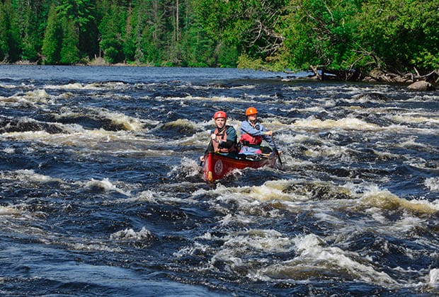 Image of two people canoeing in whitewater