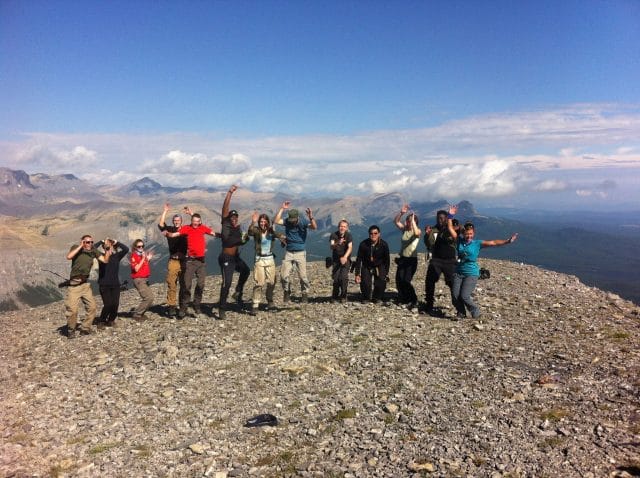 Group posing at the top of a mountain
