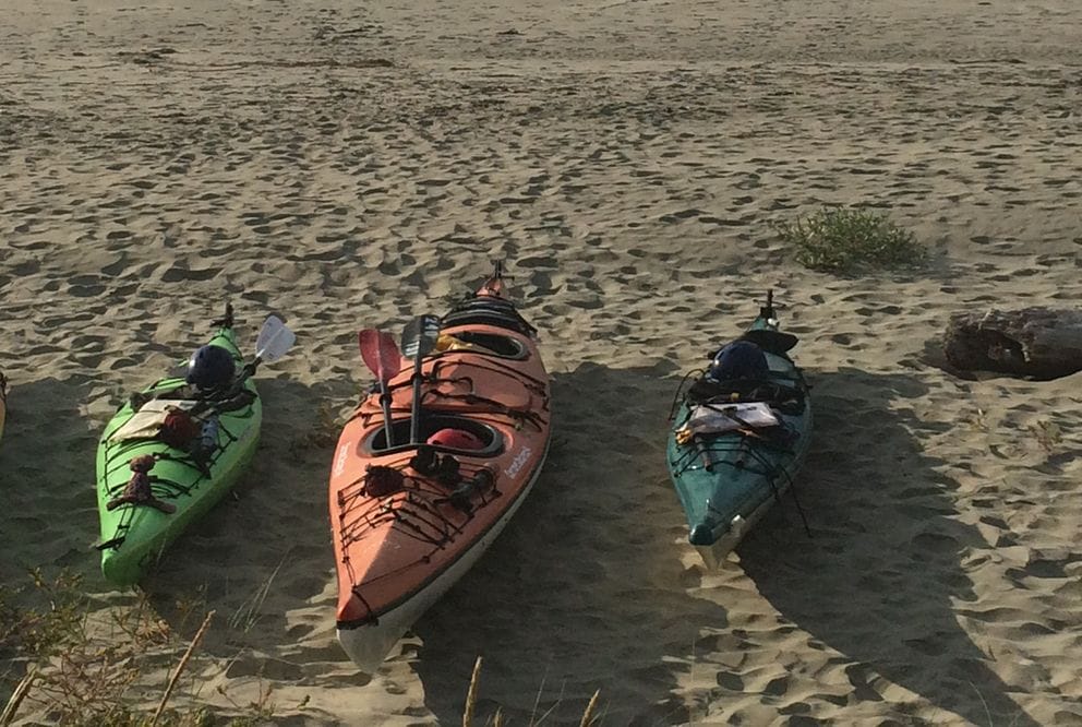 Image of 6 kayaks on the beach