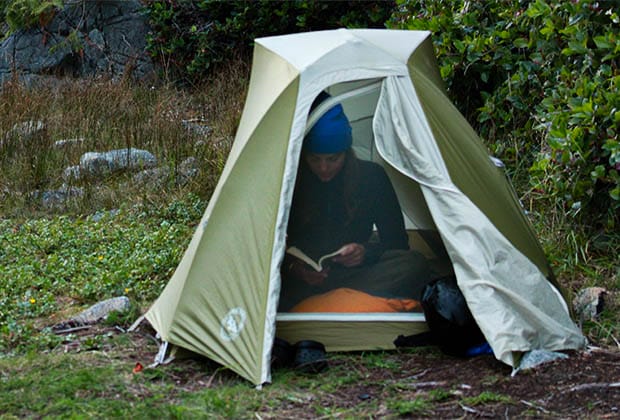 Image of a girl reading in a tent