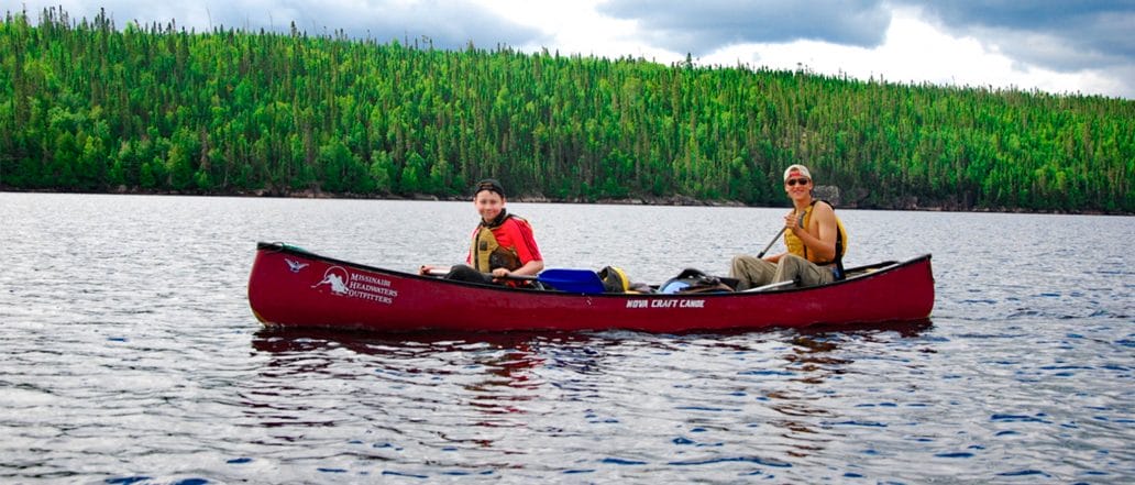 Image of two teens canoeing in flatwater