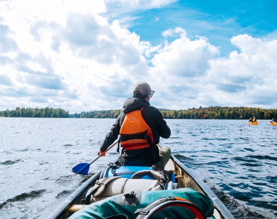 canoe paddler on sunny lake