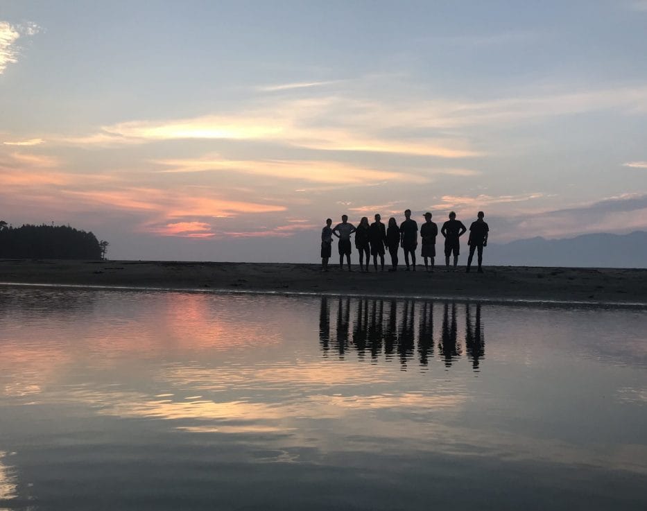 Silhouette of a group of people on shore
