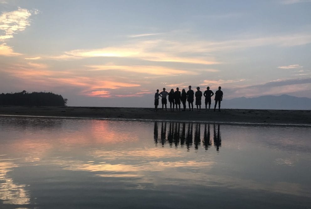 Silhouette of a group of people on shore