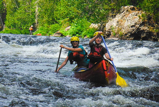 Image of two people enjoying paddling in whitewater