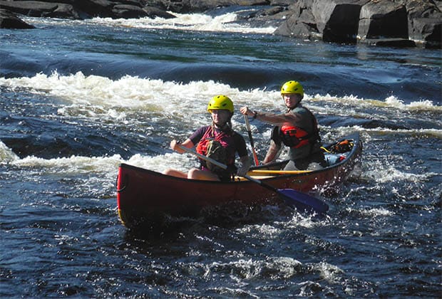 Image of two people canoeing