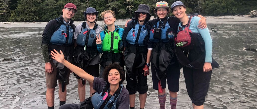 Image of a group of people in life jackets with smiles on their faces
