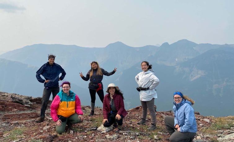Image of a group of 6 participants on the top of a mountain