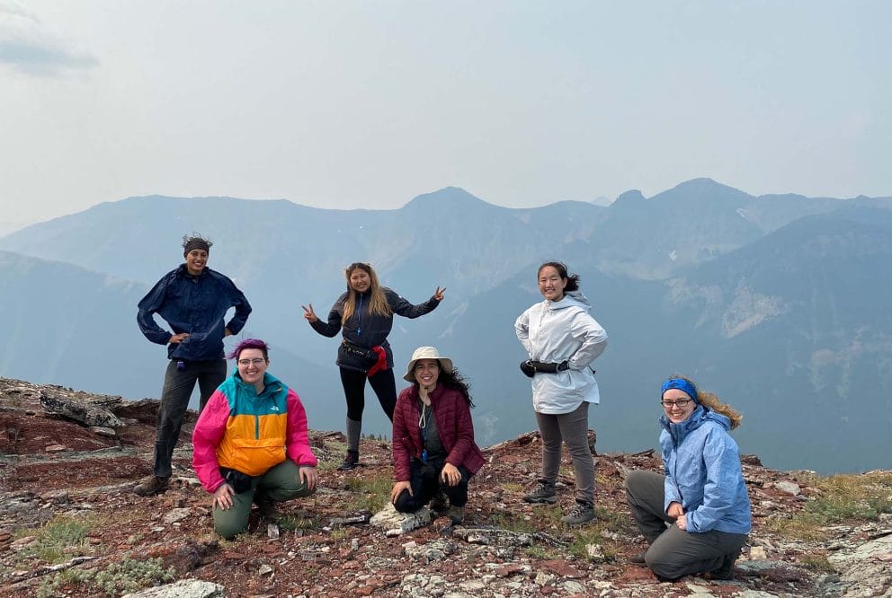 Image of a group of 6 participants on the top of a mountain
