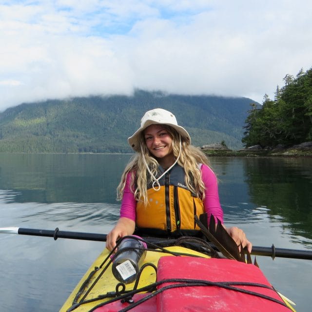 Image of a smiling kayaker on the water