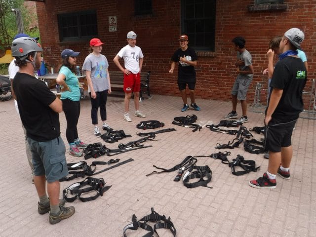 students getting ready to climb with climbing gear urban wild
