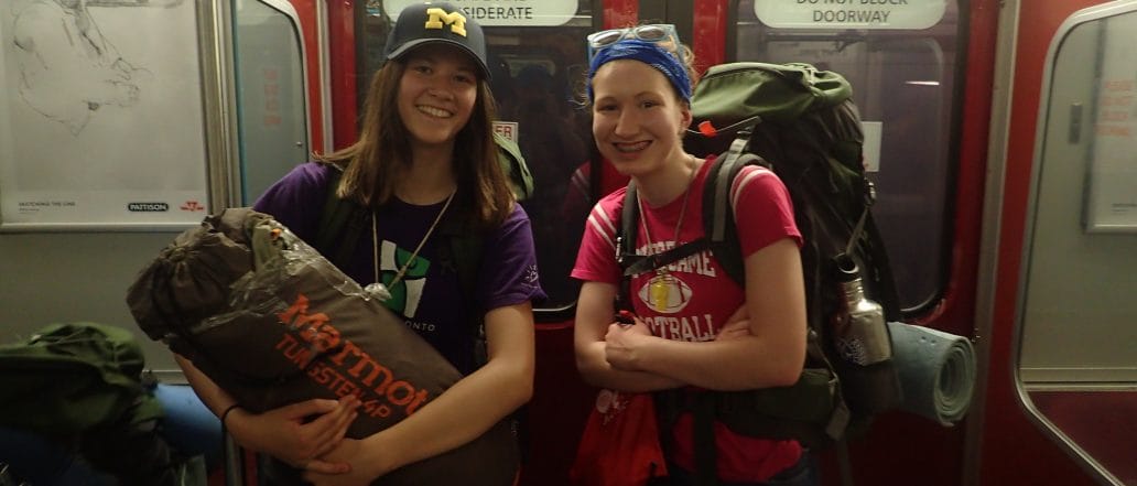 two teens standing with camp gear on the TTC