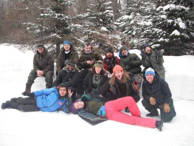 group of teens smiling in the snow
