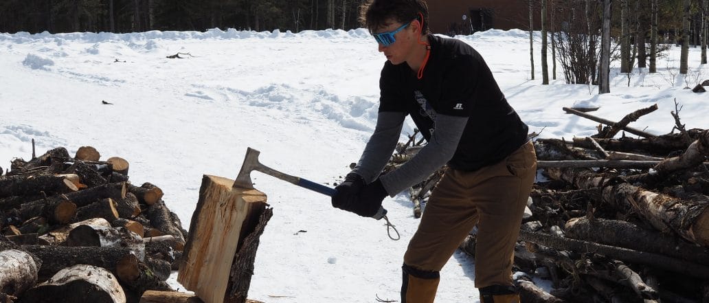 student chopping wood a kinark