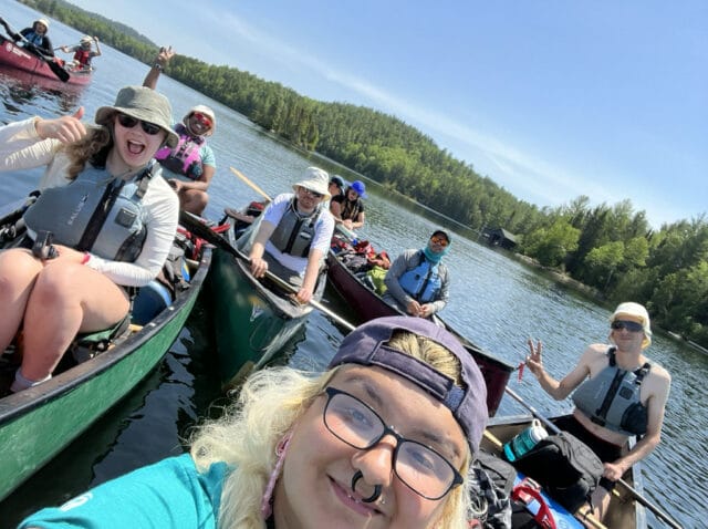 teens taking a selfie in a canoe