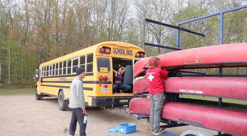 algonquin bus and canoes in parking lot