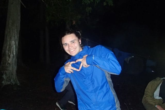a teen holding up hands in the shape of a heart