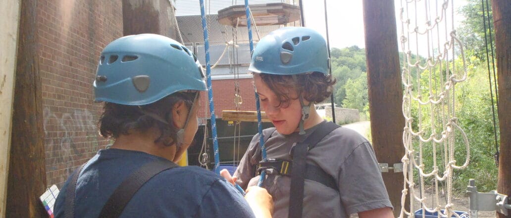 2 students in ropes course gear