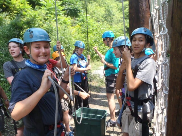 students smiling in climbing gear