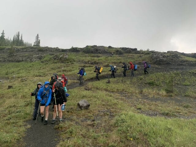 teens hiking in a line
