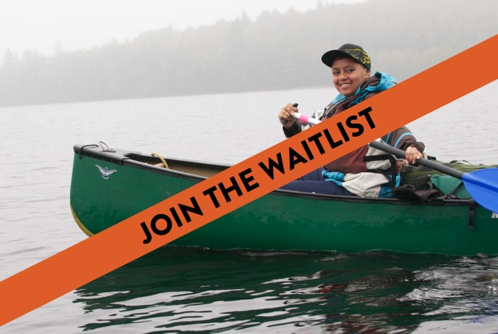 teen smiling in canoe on lake with "join the waitlist" text covering image