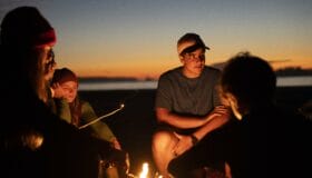 Image of teens around a campfire
